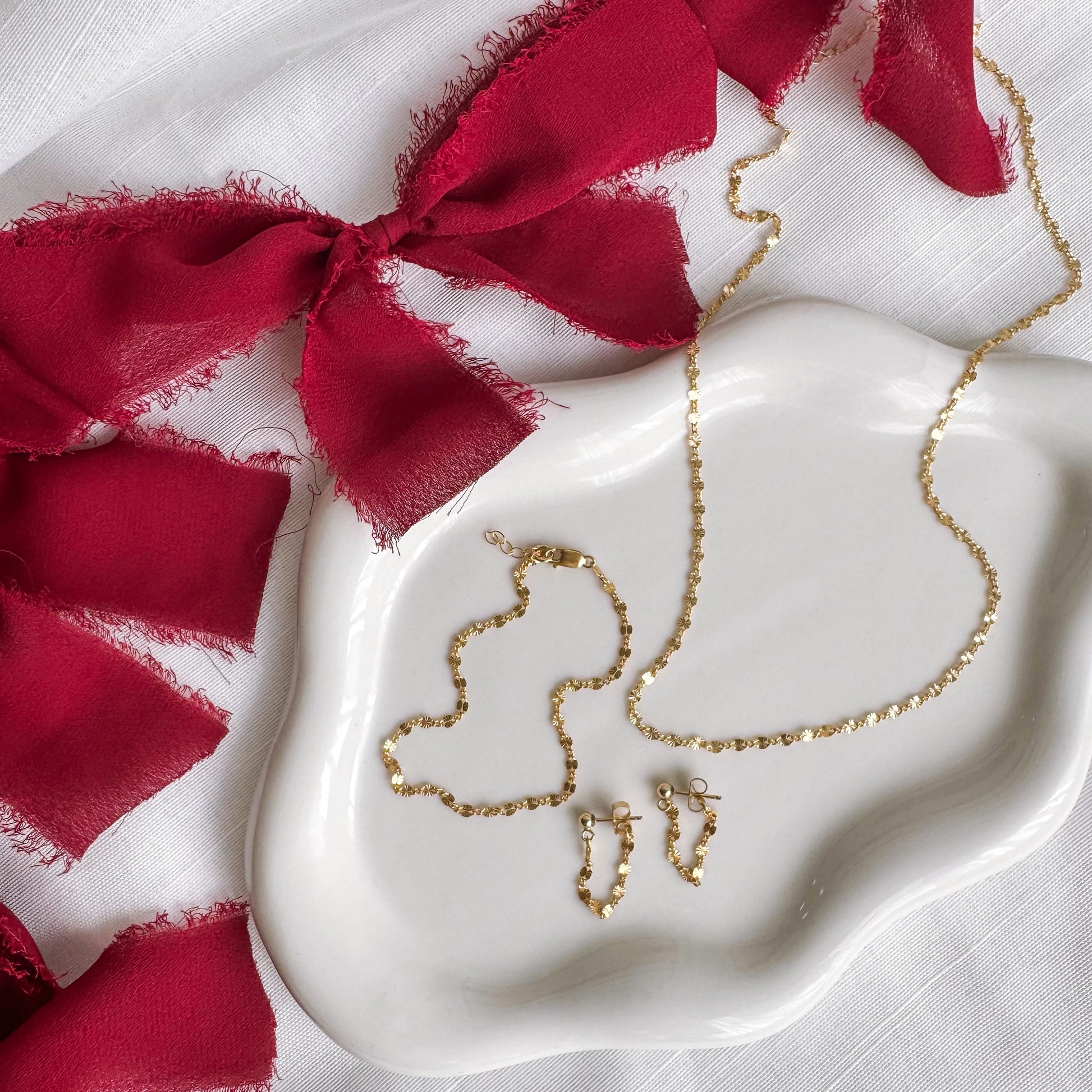 The Starburst Necklace, Bracelet, and Earring in 14K Gold Filled – a stunning celestial-inspired piece crafted with high-quality gold. Perfect for adding a radiant touch to your everyday or special occasion style. Shop elegant, timeless jewelry today!