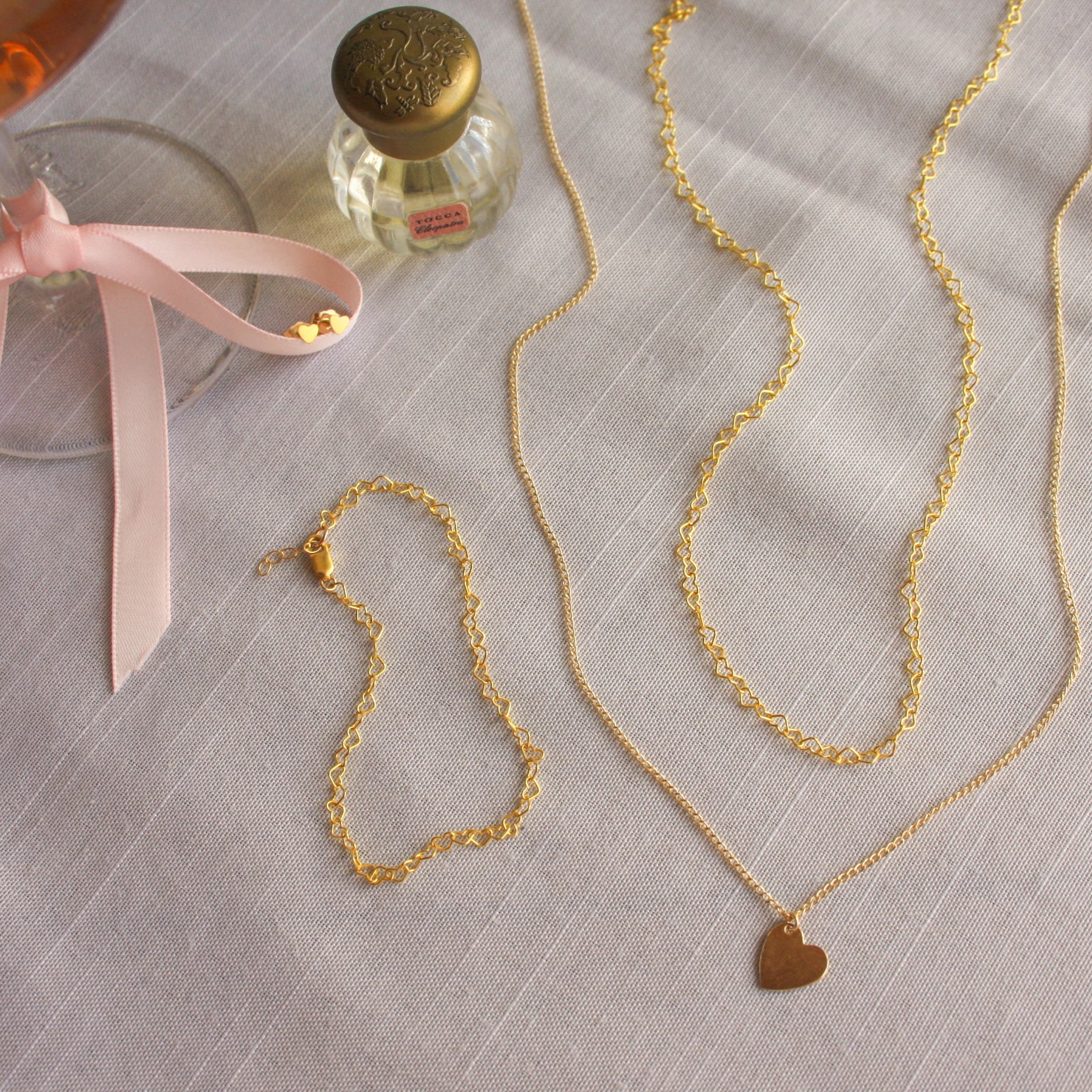 14K Gold Filled heartstring necklace and matching bracelet, with the heart charmed necklace, and heart stud earrings made for everyday wear and perfect for valentines day.