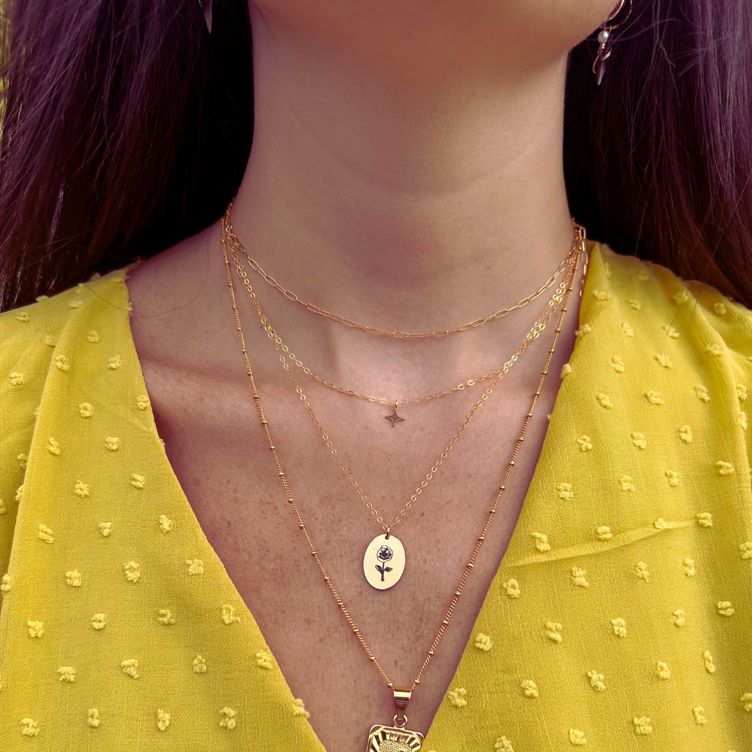 The Poppy Engraved Necklace in 14K Gold Filled – a delicate, handcrafted piece featuring an engraved poppy design. Perfect for adding a touch of elegance and meaning to your jewelry collection.