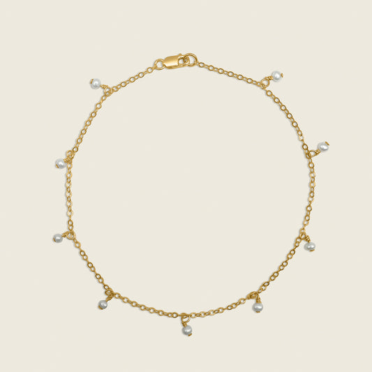 Timeless Pearl Ankle Bracelet – a delicate 14K gold-filled design featuring floating freshwater pearls. Perfect for adding a touch of elegance and sophistication to your everyday style. Shop now for timeless jewelry!