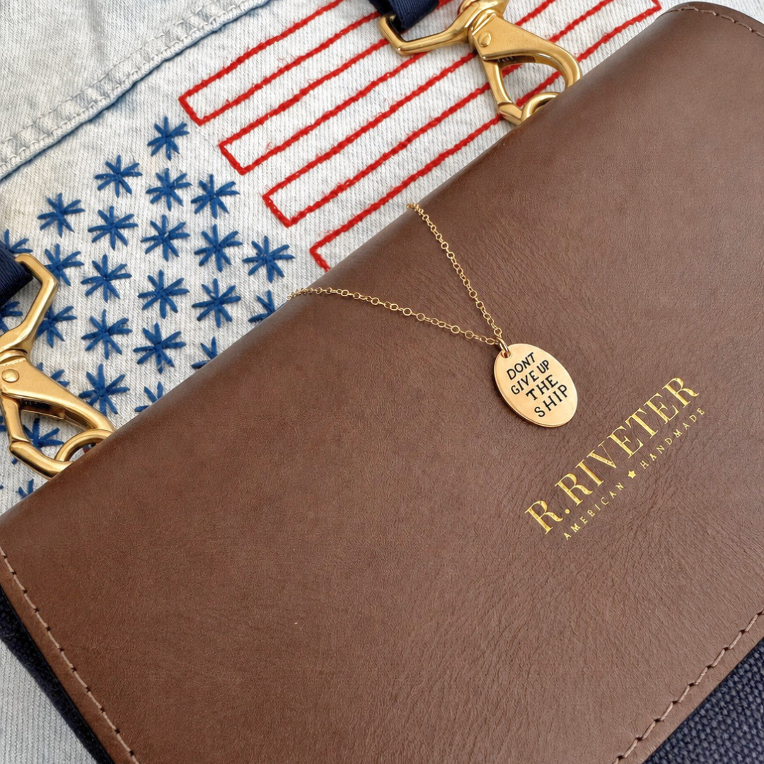 dont give up the ship flat lay on bag