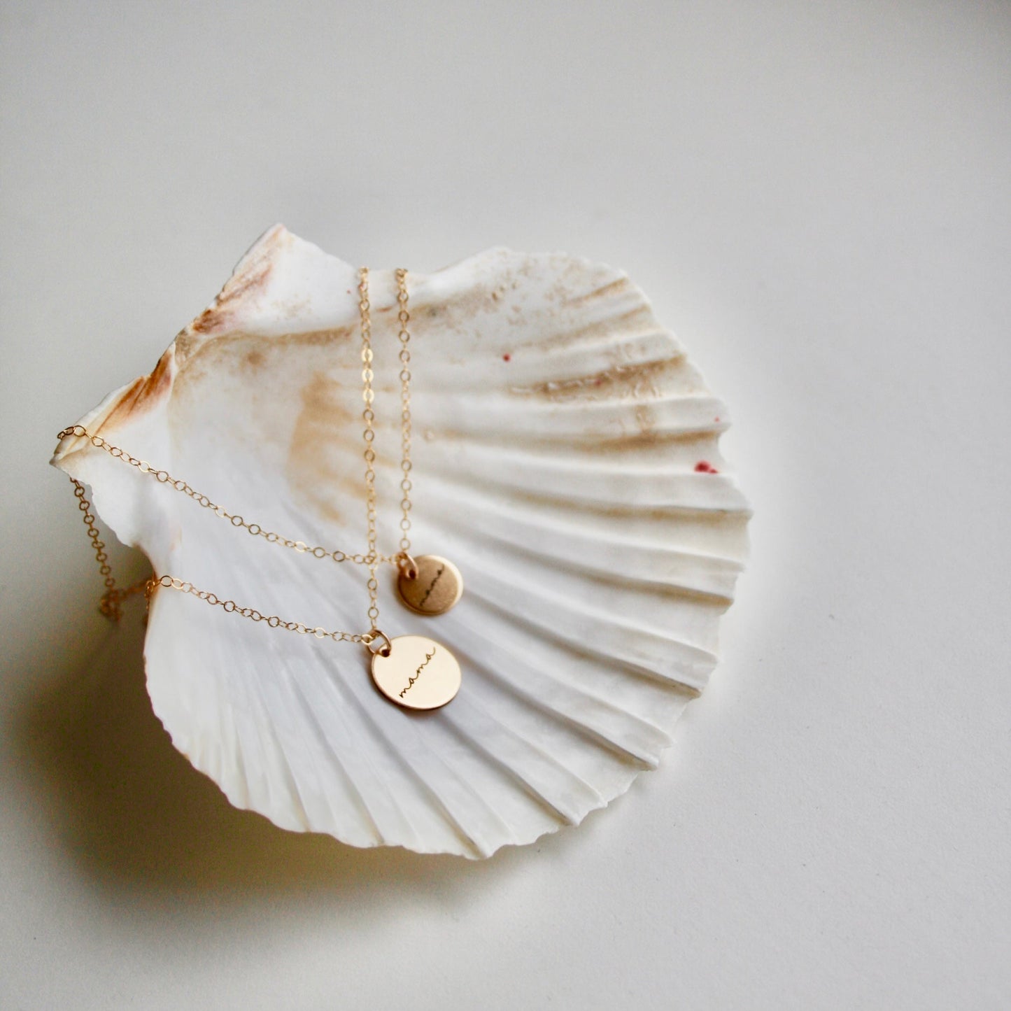 mama gold filled necklace on white shell background