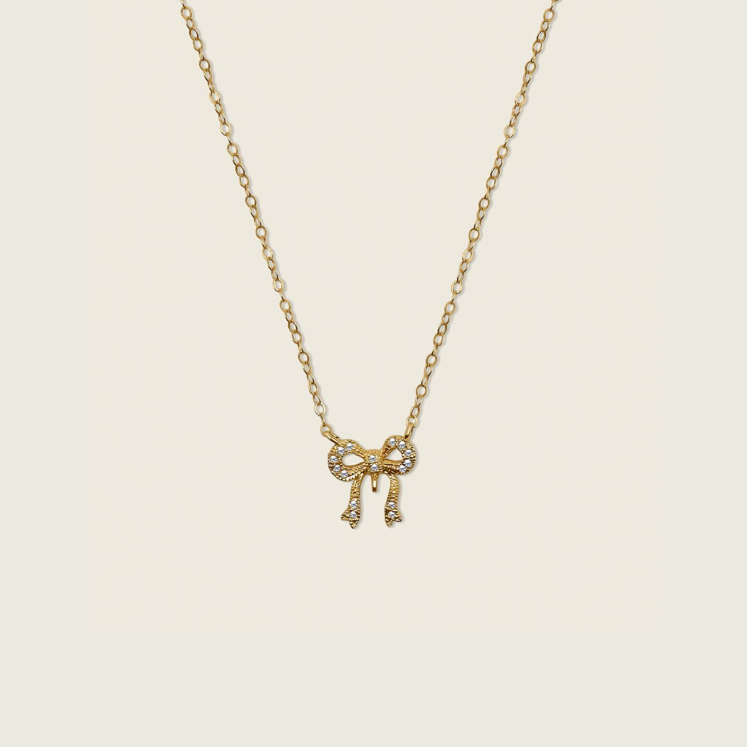 Dainty Clara Bow Necklace with a 14K Gold Filled Chain – a delicate and versatile accessory crafted for everyday wear. Perfect for enhancing any outfit with effortless elegance.