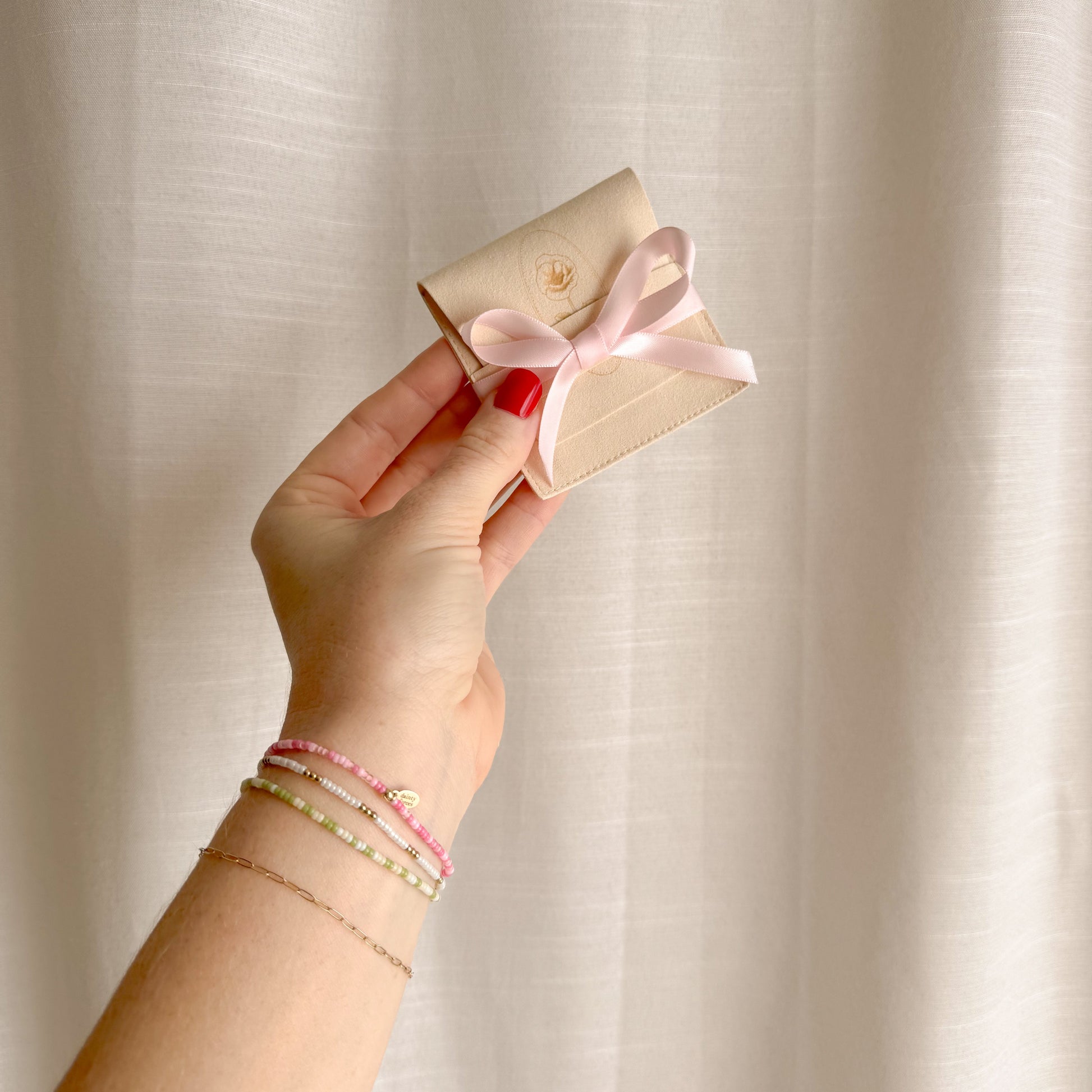 Girly Pop Pink Beaded Bracelet with packaging and a pink bow made for gifting for valetines, galentines, or for yourself. 