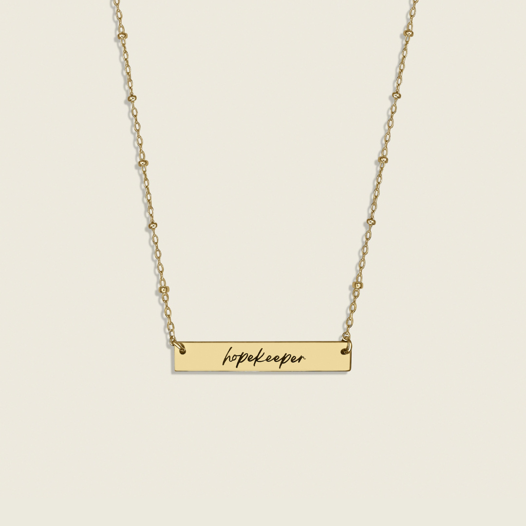 Hopekeeper Necklace in 14K Gold Filled – a meaningful collaboration with Homefront Heroes Ministries. This handcrafted, inspirational piece honors service and hope, perfect for those seeking stylish, uplifting jewelry.