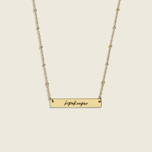 Hopekeeper Necklace in 14K Gold Filled – a meaningful collaboration with Homefront Heroes Ministries. This handcrafted, inspirational piece honors service and hope, perfect for those seeking stylish, uplifting jewelry.