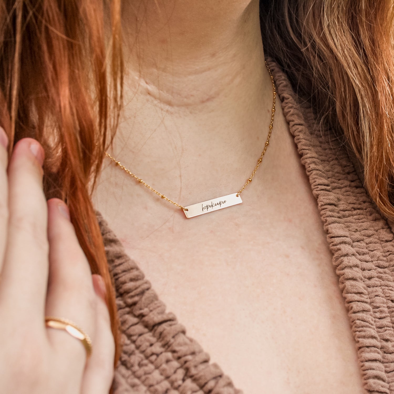 "Hopekeeper Necklace in 14K Gold Filled – a meaningful collaboration with Homefront Heroes Ministries. This handcrafted, inspirational piece honors service and hope, perfect for those seeking stylish, uplifting jewelry."