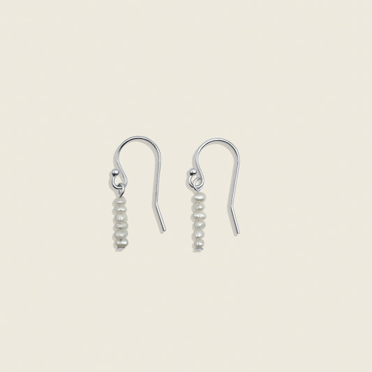 Pearl Stardust Earrings – dainty pearl drop earrings crafted with delicate seed pearls, perfect for adding a touch of elegance to any look. Shop these timeless accessories today!