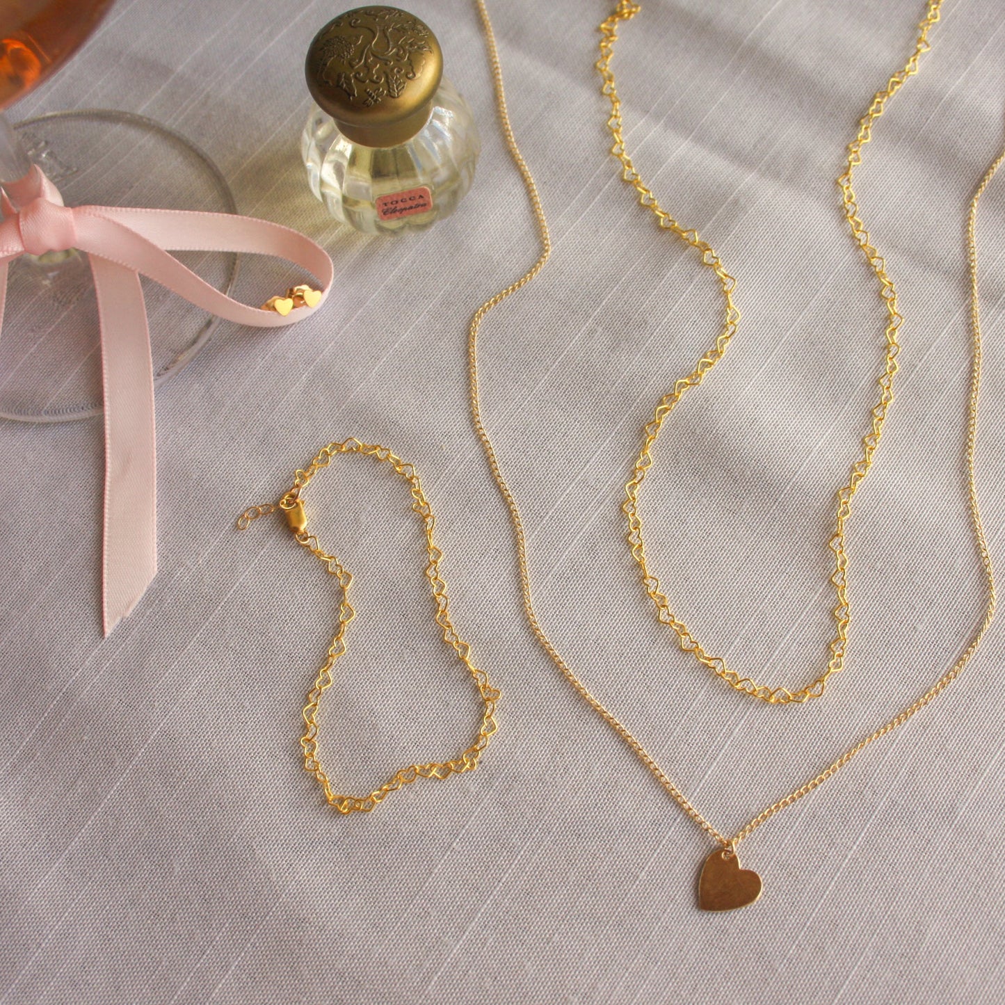 14K Gold Filled heartstring necklace and matching bracelet, with the heart charmed necklace, and heart stud earrings made for everyday wear and perfect for valentines day. 