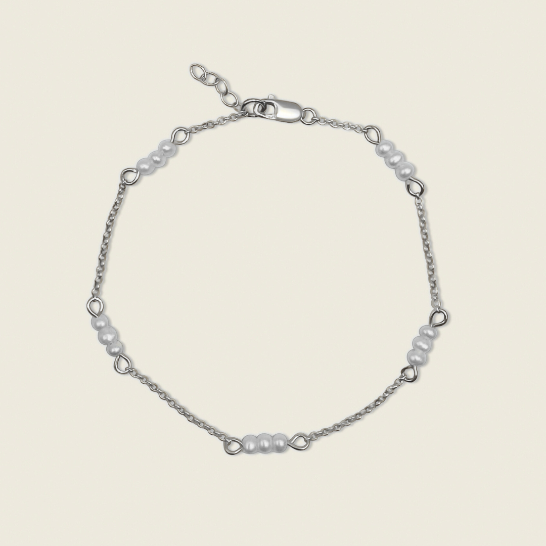 The Madelyn Bracelet – a timeless accessory featuring freshwater pearls and sterling silver accents. Perfect for adding a touch of elegance and sophistication to any look. Shop now for high-quality, handcrafted jewelry!