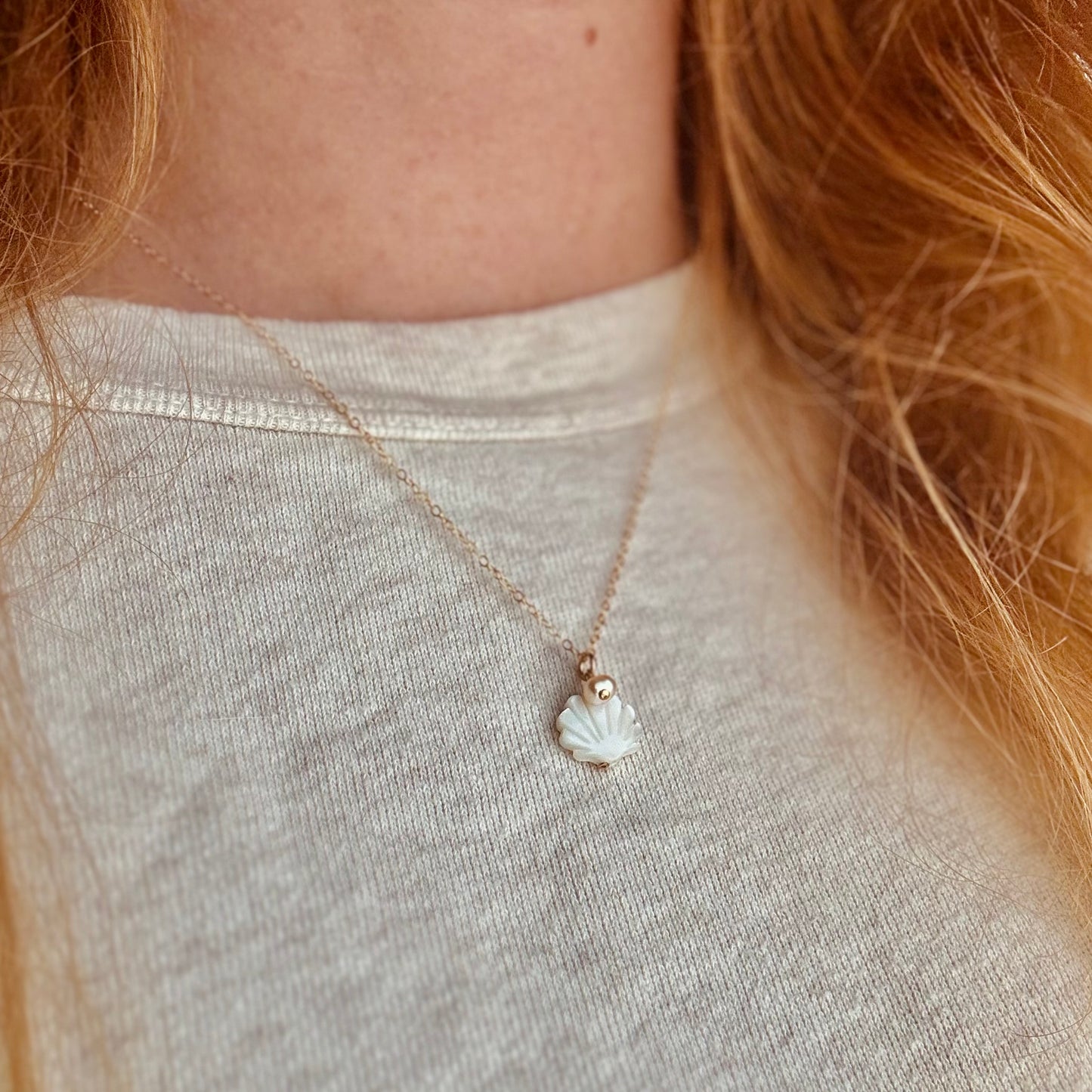 The Sylvia Necklace – featuring a Mother of Pearl shell charm paired with a pink freshwater pearl in 14K Gold Filled. A delicate and elegant accessory perfect for adding a touch of coastal charm to your style