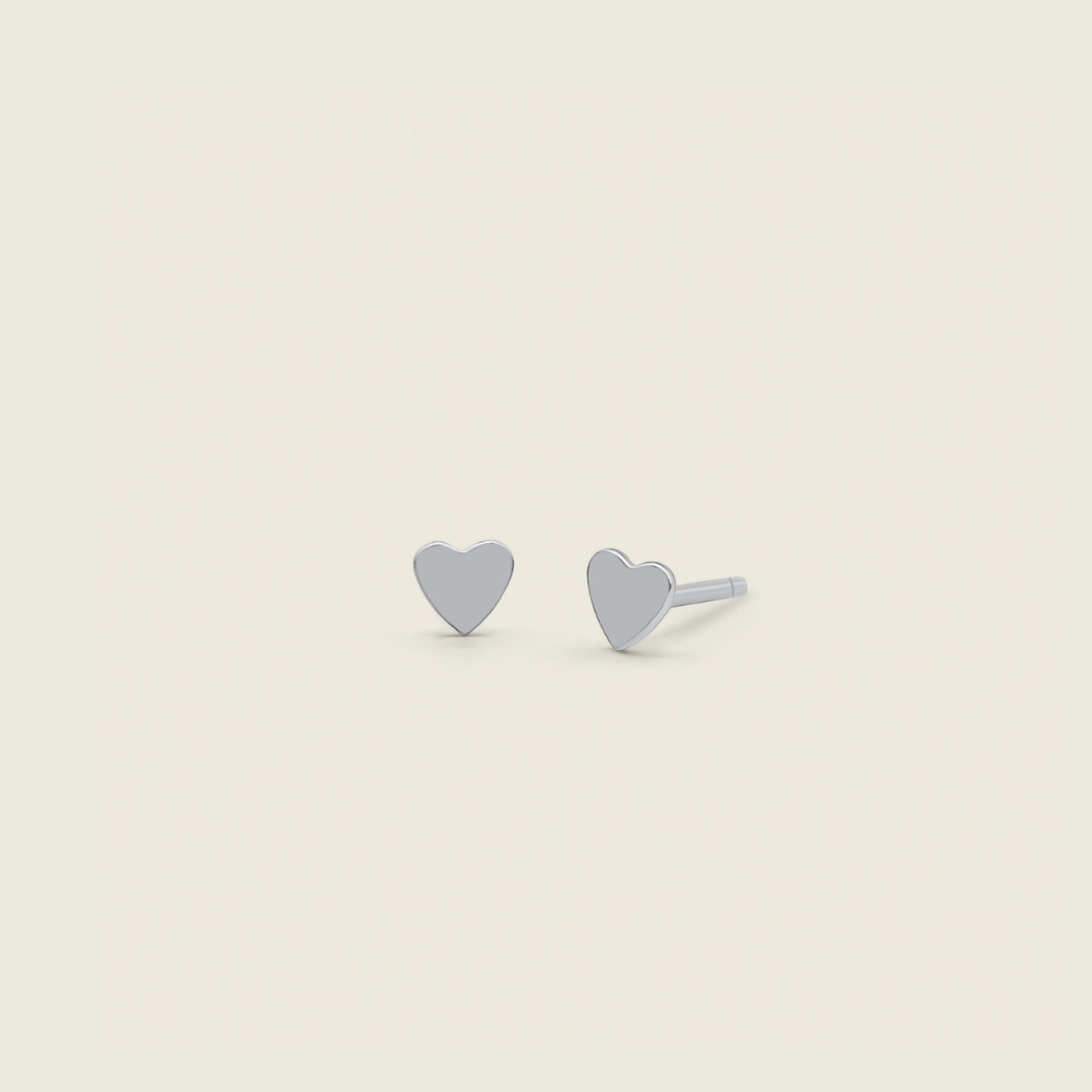 dainty heart stud earrings in sterling silver product photo and come with butterfly backings - minimal for everyday wear